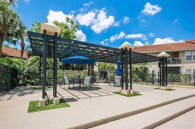 view of property's community featuring a pergola, a patio, and fence