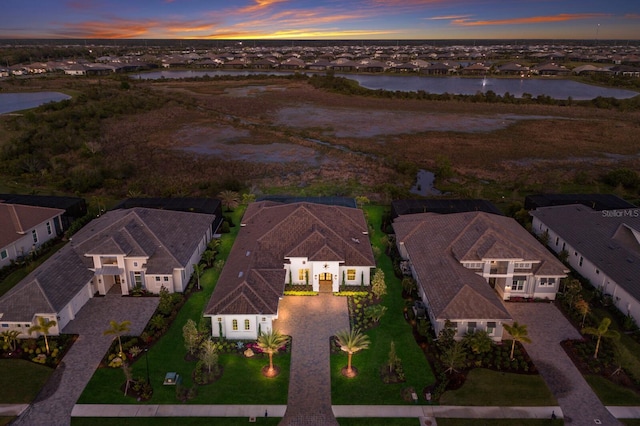 birds eye view of property with a residential view and a water view