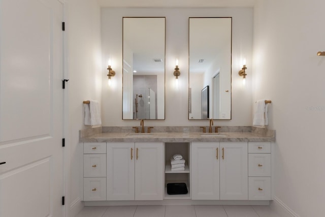 full bathroom featuring double vanity, visible vents, tile patterned floors, and a sink