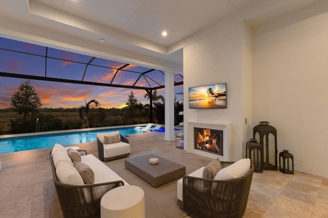 pool with glass enclosure, an outdoor living space with a fireplace, and a patio area