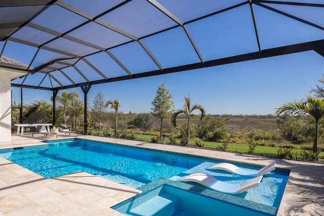 view of swimming pool with glass enclosure, a pool with connected hot tub, and a patio area