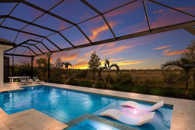 pool at dusk featuring an outdoor pool, a lanai, and a patio area