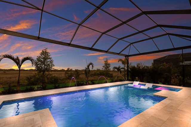 pool with glass enclosure and a patio