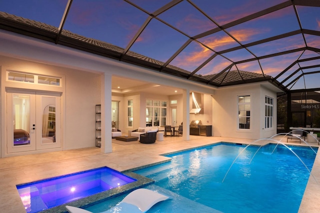 view of swimming pool featuring a pool with connected hot tub, french doors, outdoor lounge area, area for grilling, and a patio