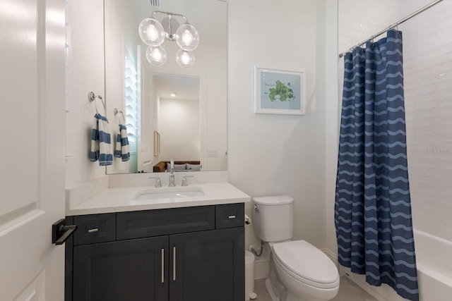 full bath with toilet, vanity, and shower / bath combo