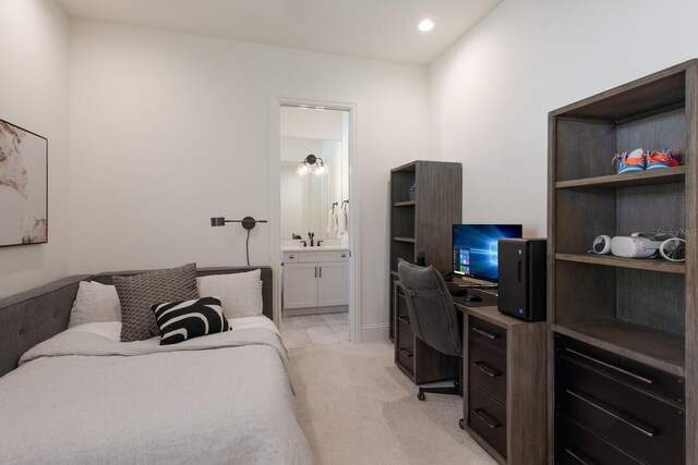 bedroom featuring recessed lighting, light colored carpet, ensuite bathroom, and a sink