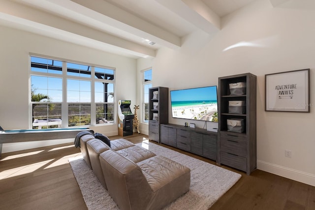 living room with beamed ceiling, dark wood-style floors, and baseboards