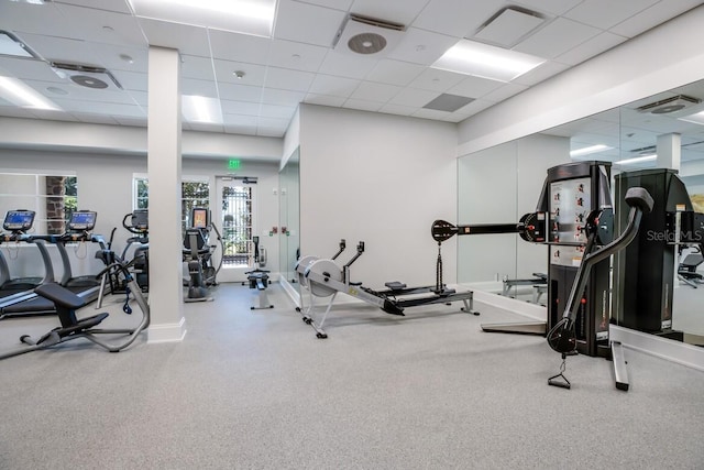 exercise room with visible vents and a paneled ceiling