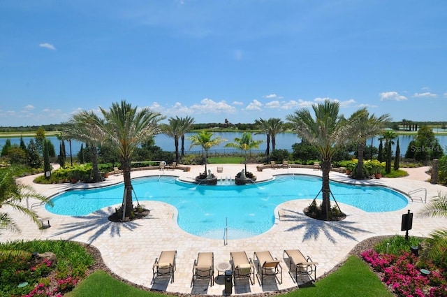 community pool with a patio and a water view