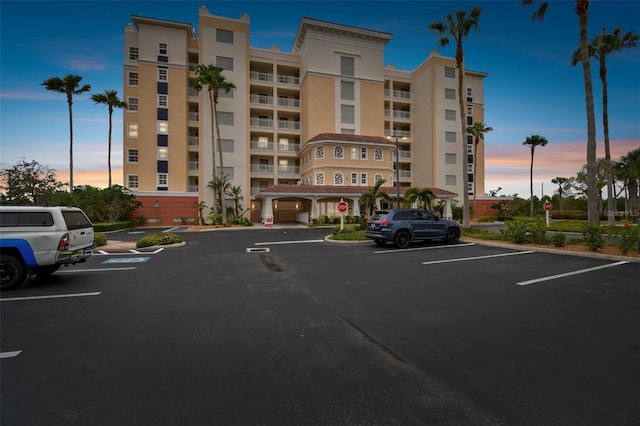 property at dusk with uncovered parking