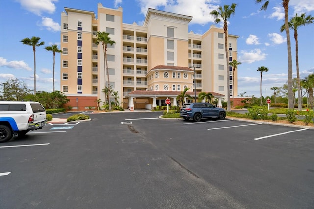 view of building exterior with uncovered parking