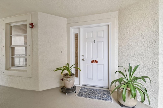 entrance to property featuring stucco siding