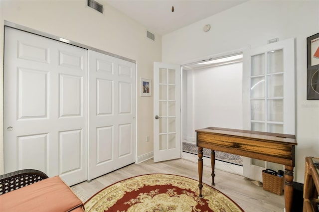 office featuring light wood-style floors, visible vents, and french doors