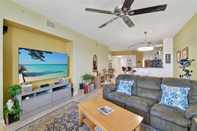 living area with visible vents and a ceiling fan