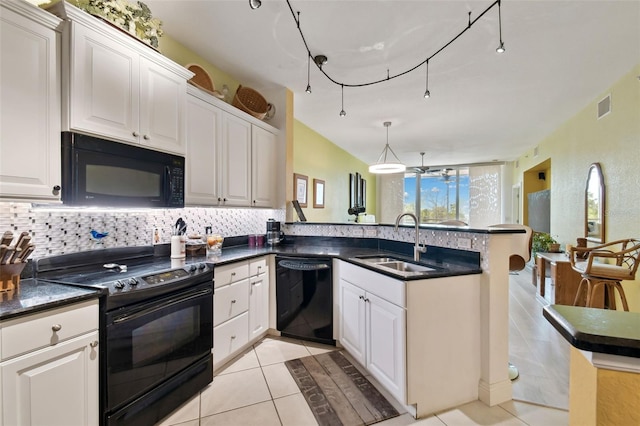 kitchen featuring a sink, visible vents, backsplash, and black appliances