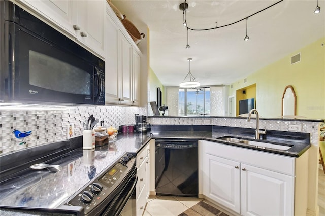 kitchen with visible vents, black appliances, a sink, white cabinetry, and decorative backsplash