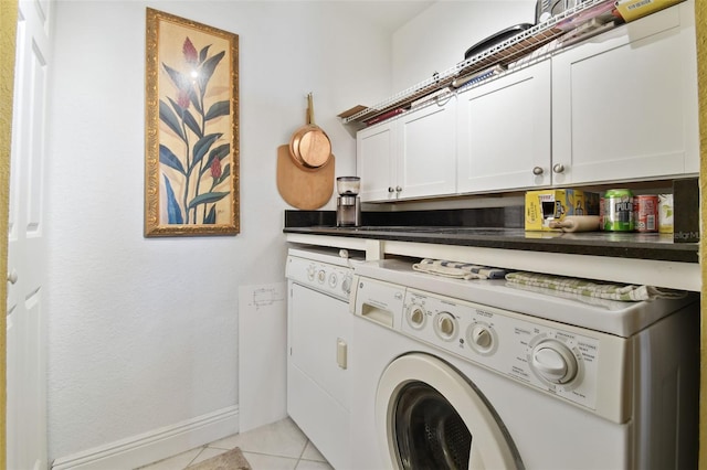 laundry room with cabinet space, washer and dryer, baseboards, and light tile patterned flooring