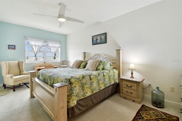 bedroom featuring light carpet, ceiling fan, and baseboards