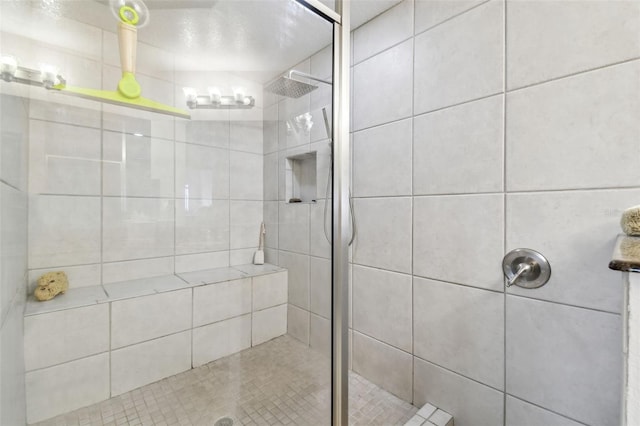 full bath with a tile shower