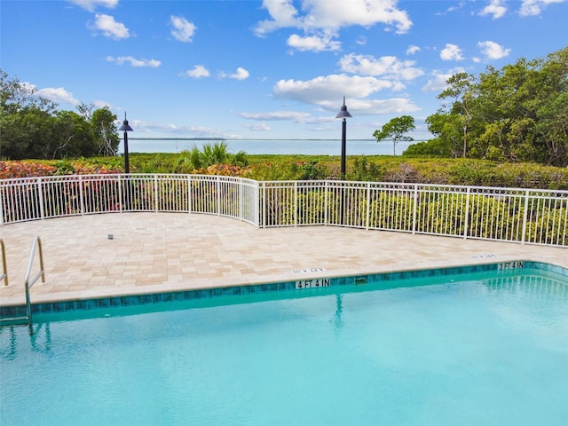 pool featuring a patio area and fence