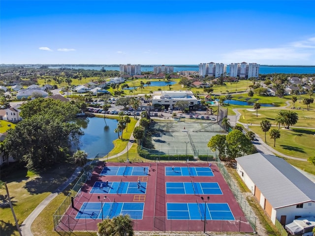 drone / aerial view featuring a city view and a water view