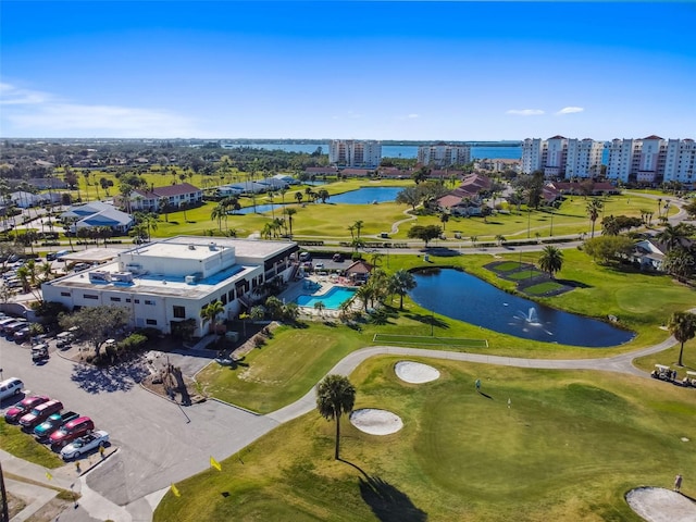 bird's eye view with view of golf course, a view of city, and a water view