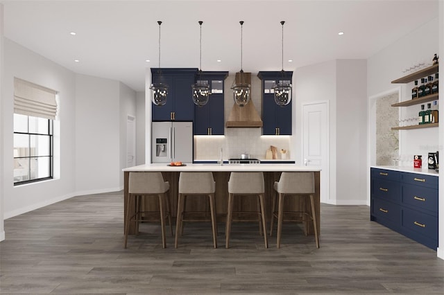 6137 Grove Blvd, Punta Gorda, FL 33982 - kitchen with stainless steel fridge with ice dispenser, blue cabinetry, open shelves, tasteful backsplash, and recessed lighting