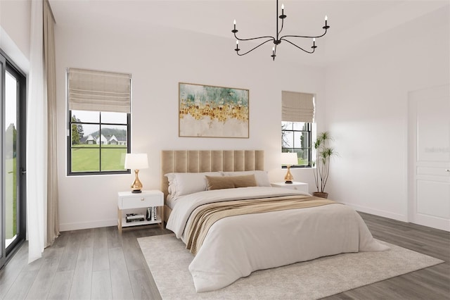6137 Grove Blvd, Punta Gorda, FL 33982 - bedroom with a chandelier, wood finished floors, and baseboards