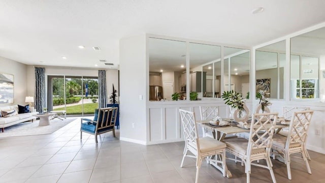 dining area featuring light tile patterned floors, baseboards, and recessed lighting