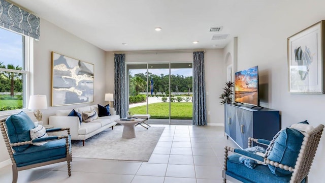 tiled living room with recessed lighting, visible vents, and baseboards