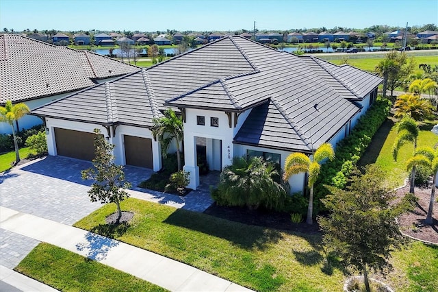 4629 Antrim Dr, Sarasota, FL 34240 - view of front of house with stucco siding, decorative driveway, a residential view, and a garage