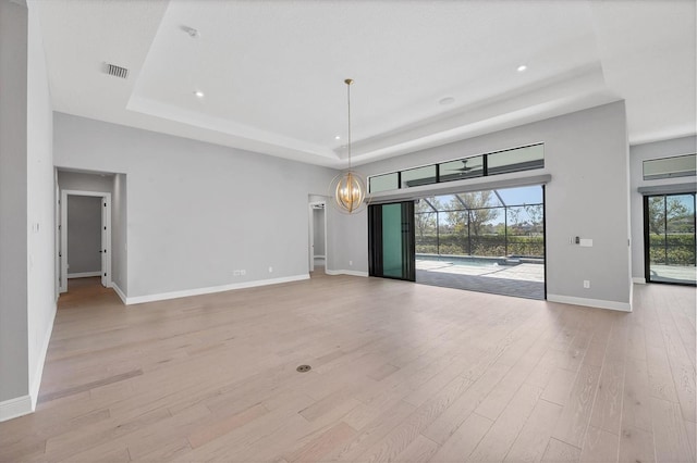 4629 Antrim Dr, Sarasota, FL 34240 - unfurnished living room with a tray ceiling, visible vents, light wood finished floors, and recessed lighting