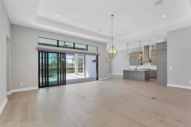 4629 Antrim Dr, Sarasota, FL 34240 - unfurnished living room featuring a chandelier, baseboards, recessed lighting, and light wood-style floors