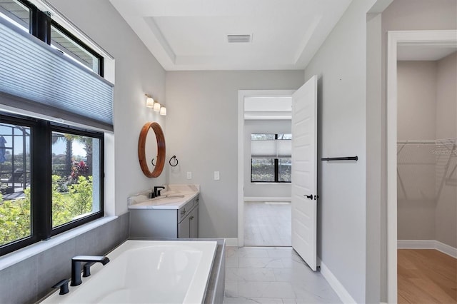 4629 Antrim Dr, Sarasota, FL 34240 - full bathroom featuring a washtub, vanity, marble finish floor, baseboards, and visible vents