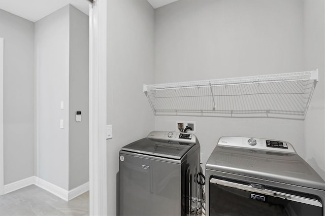 4629 Antrim Dr, Sarasota, FL 34240 - laundry area featuring baseboards, washer and clothes dryer, and laundry area