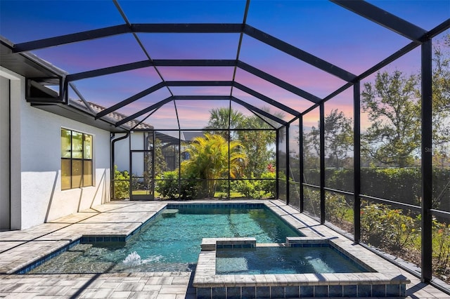 4629 Antrim Dr, Sarasota, FL 34240 - pool at dusk featuring a pool with connected hot tub, a patio area, and a lanai