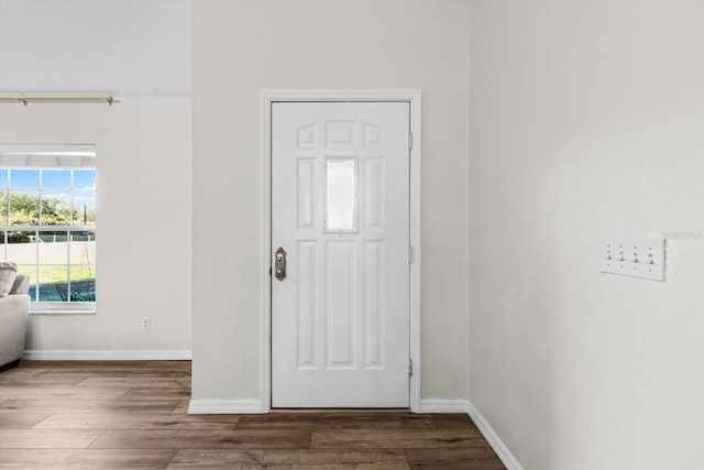 foyer entrance featuring baseboards and wood finished floors