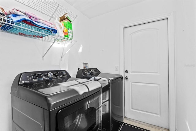 clothes washing area with washer and dryer and laundry area