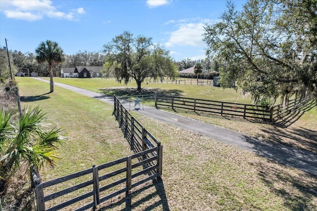 view of yard with a rural view and fence