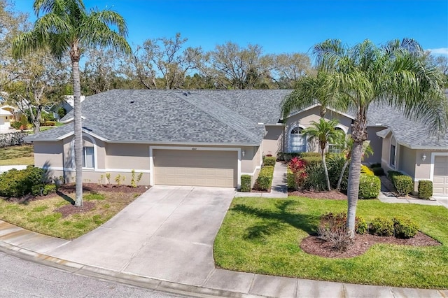 ranch-style home with stucco siding, a garage, roof with shingles, and a front lawn