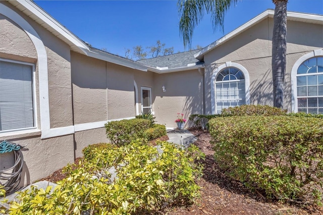 doorway to property with stucco siding