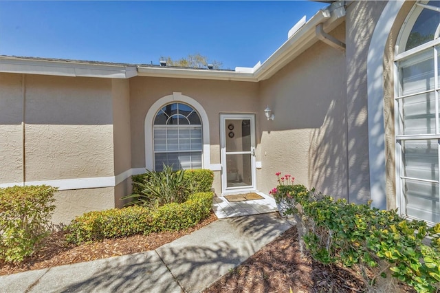 doorway to property with stucco siding