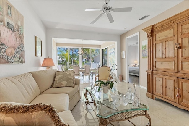 living room featuring light tile patterned flooring, baseboards, visible vents, and ceiling fan