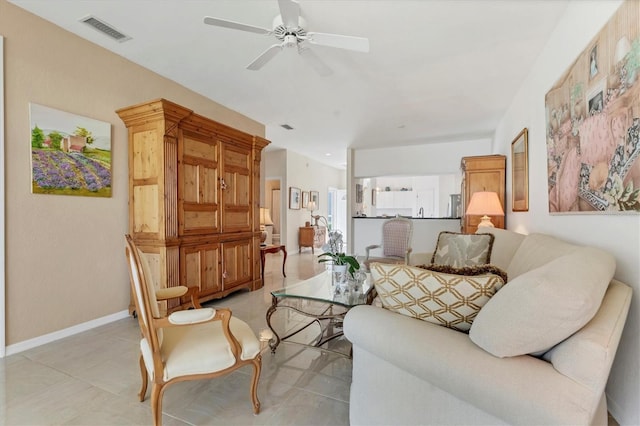 living area with visible vents, baseboards, and a ceiling fan