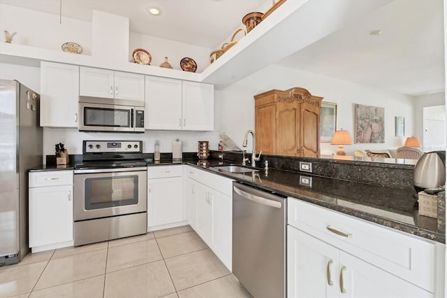 kitchen with white cabinetry, stainless steel appliances, and a sink