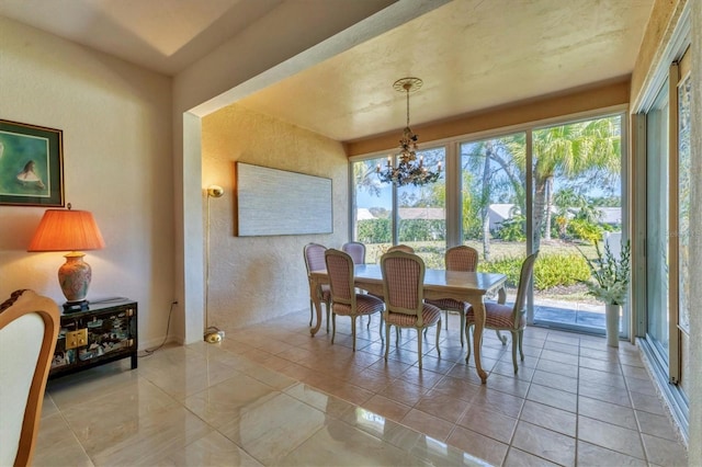 dining room featuring light tile patterned floors and a notable chandelier