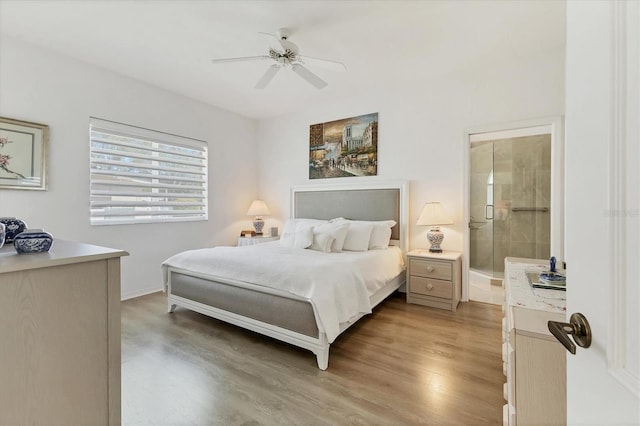 bedroom featuring ceiling fan, light wood-style floors, baseboards, and connected bathroom