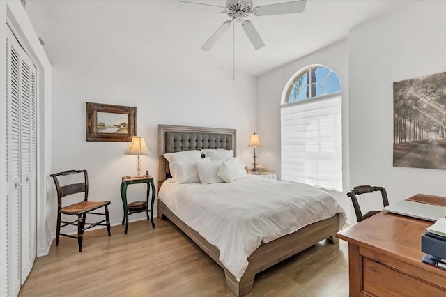 bedroom featuring light wood-type flooring, a closet, and ceiling fan