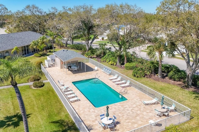 pool with a yard, a patio, and fence