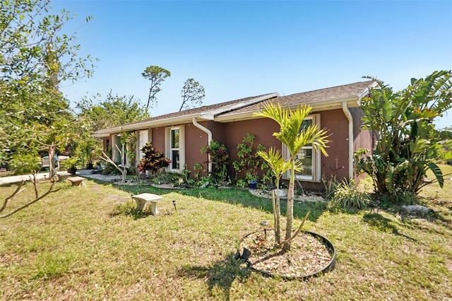 view of front of property with a front lawn and stucco siding